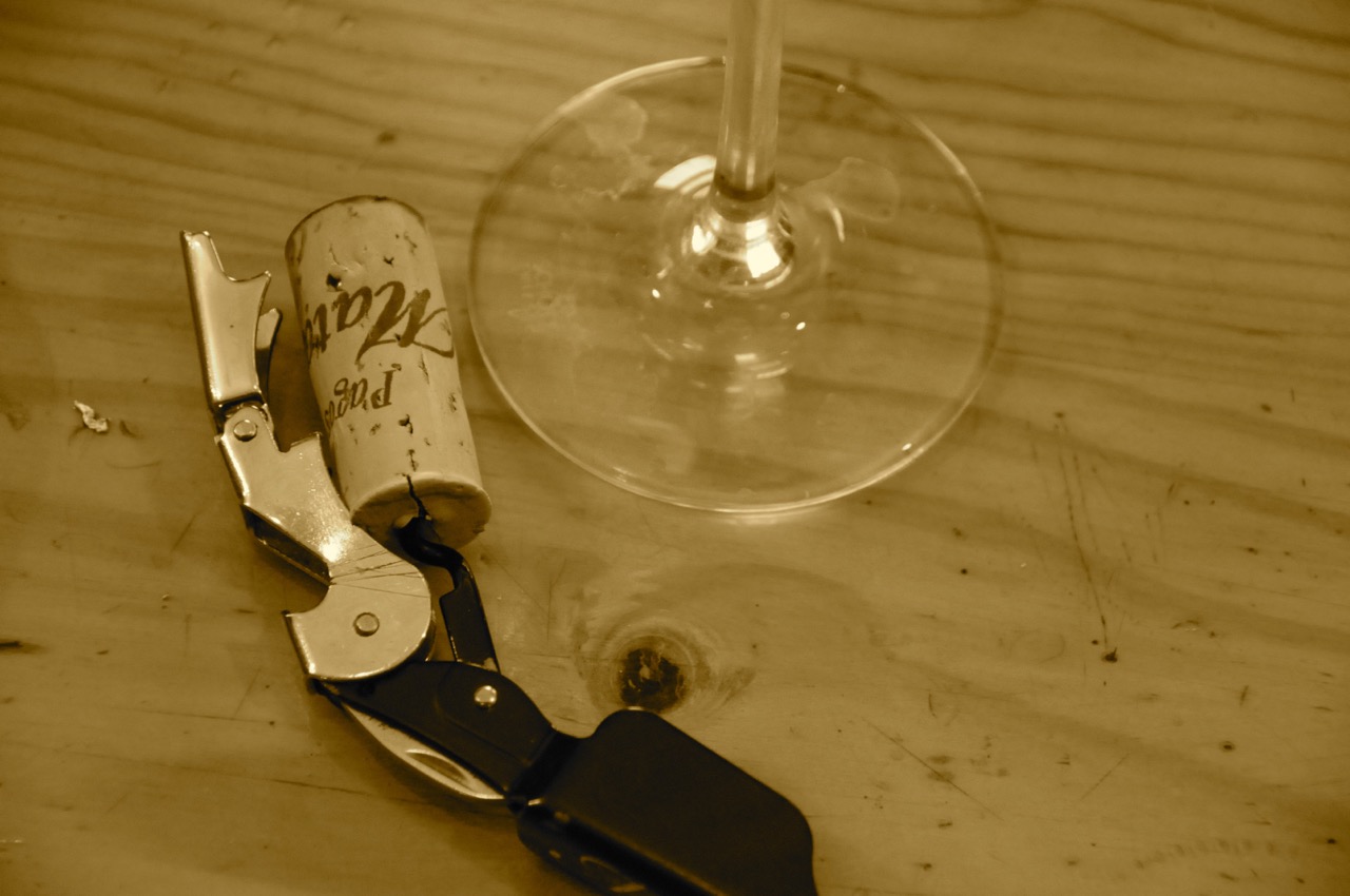 cork screw next to a wine glass