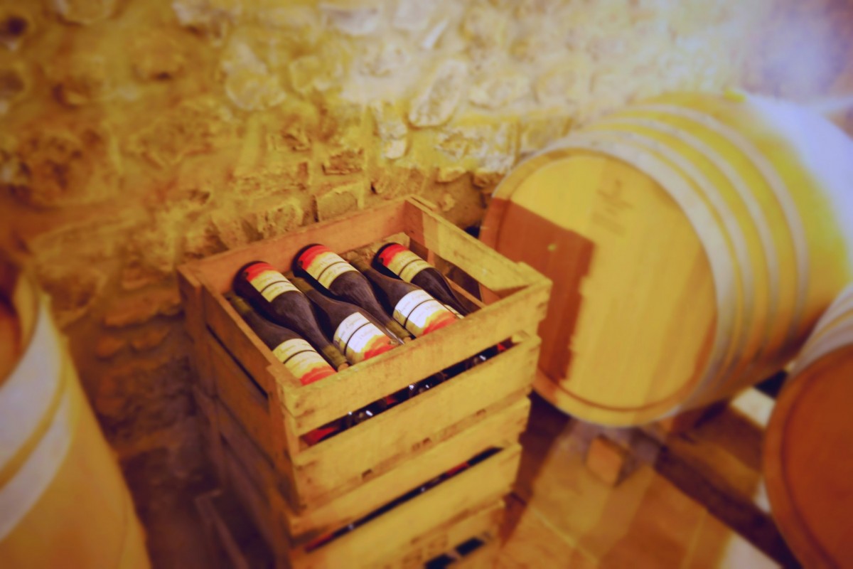 Bottles of Régnié from Domaine Lagneau stacked in crates