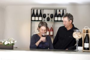 Véronique of Domaine de Font-Sane sipping wine while her husband Bernard looks on.