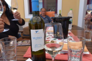 Bottle of Methea white wine next to a wine glass