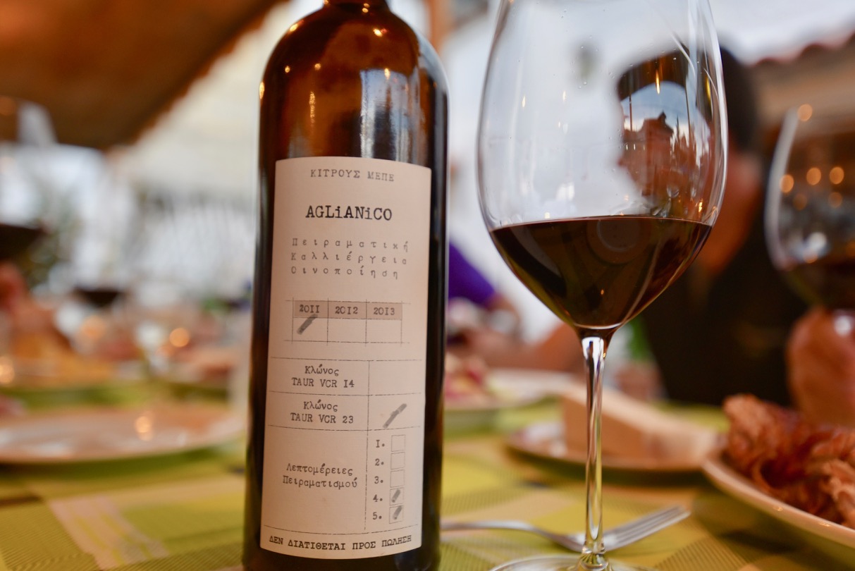 Bottle of KITRVS winery Aglianico on a table with a wine glass