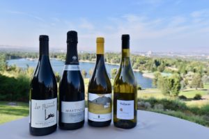 Row of 4 bottles of wine with the Lakeridge Golf course in the background