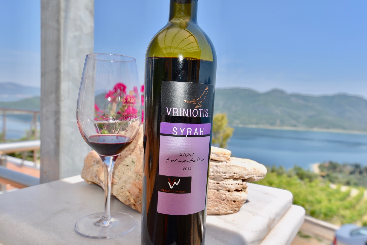 Bottle of Syrah from Vriniotis winery next to a wine glass