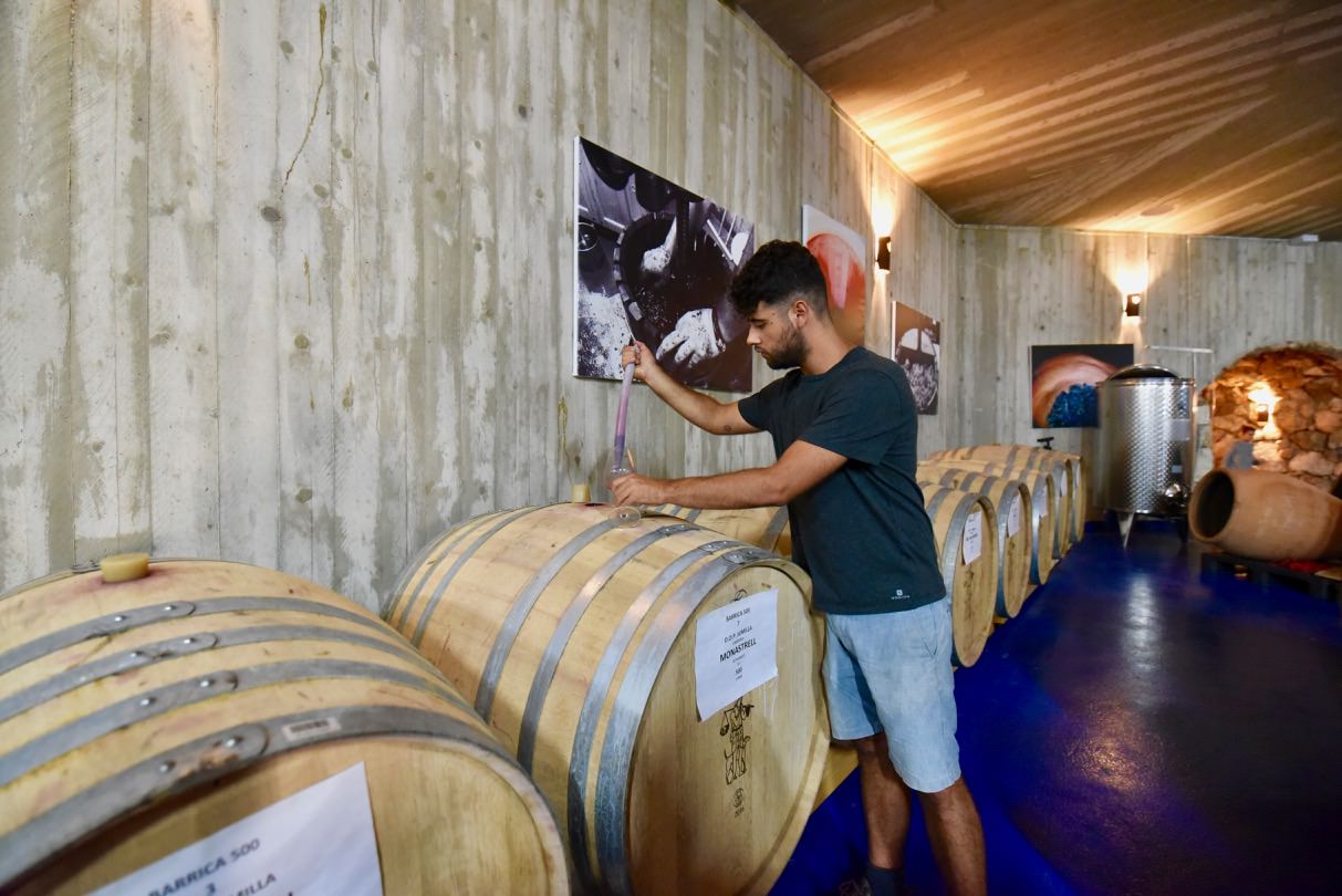 Carlos Garcia of Bodega Cerron tasting wines from barrels.