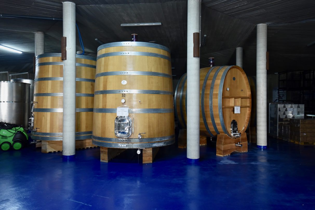 Large oak barrels at the Bodega Cerron that contain Petit Verdot