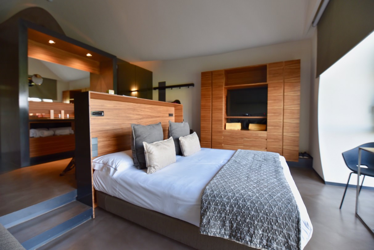 Inside of the hotel room at Hotel Mastinell showing a bed.