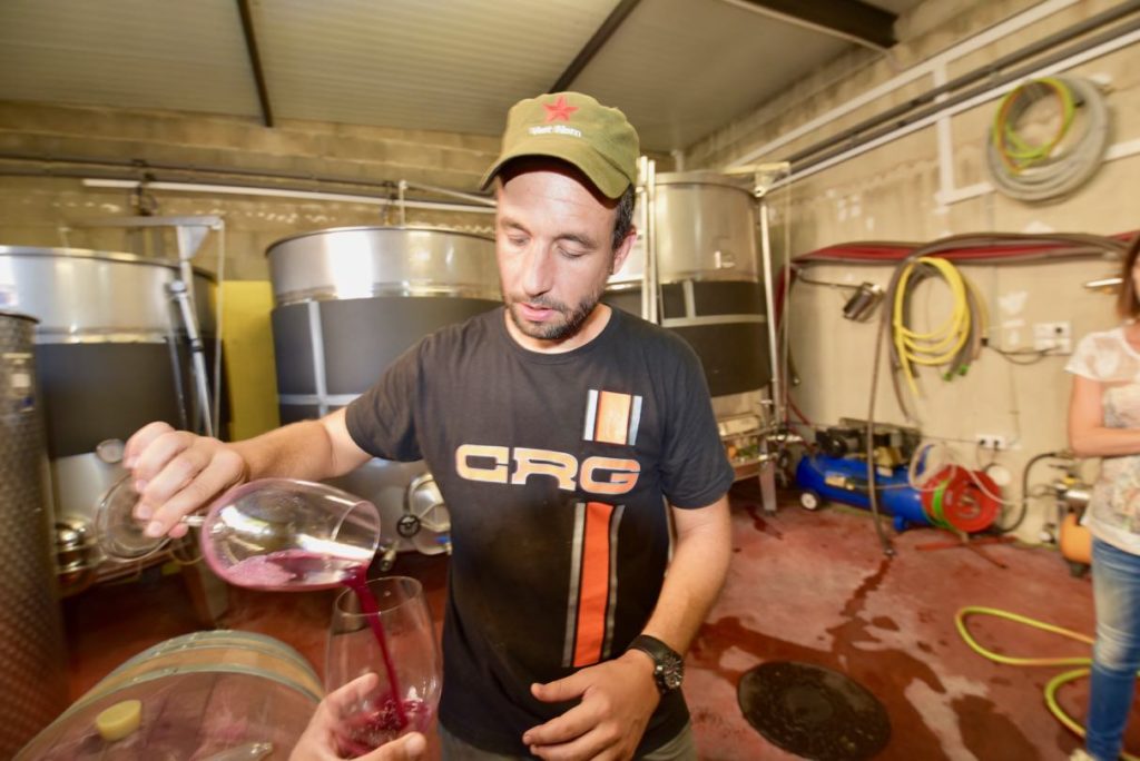 A man pouring wine into a glass