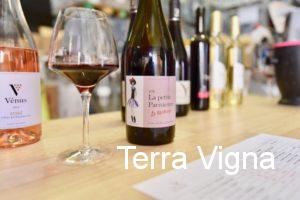 bottle of red wine on a table with a glass of wine.