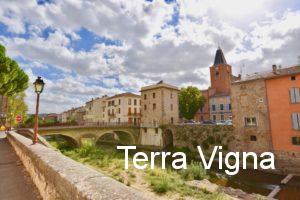 Old village in France with a bridge and a river.