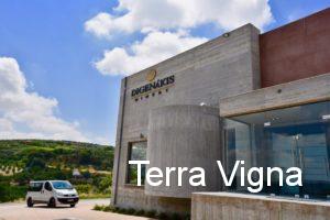 A winery building of Digenakis winery with a car parked next to it.
