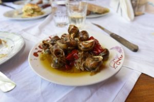 Cooked snails in the Cretan style on a plate.